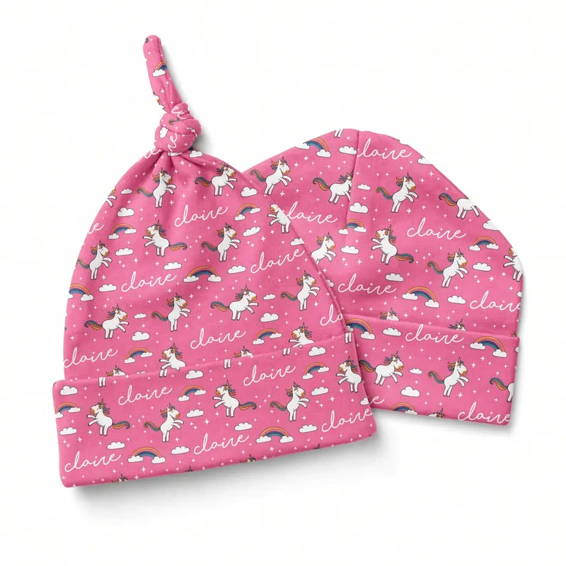 Pink knot hats with a small repeating print, one standing inside the other