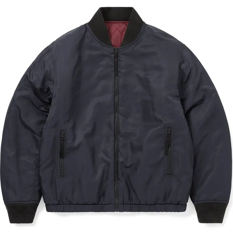 Navy reversible bomber with a red quilted lining showing at the neck