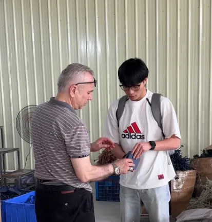 Will Watters on a workshop visit, walking the cutting room with a JaceApparel producer