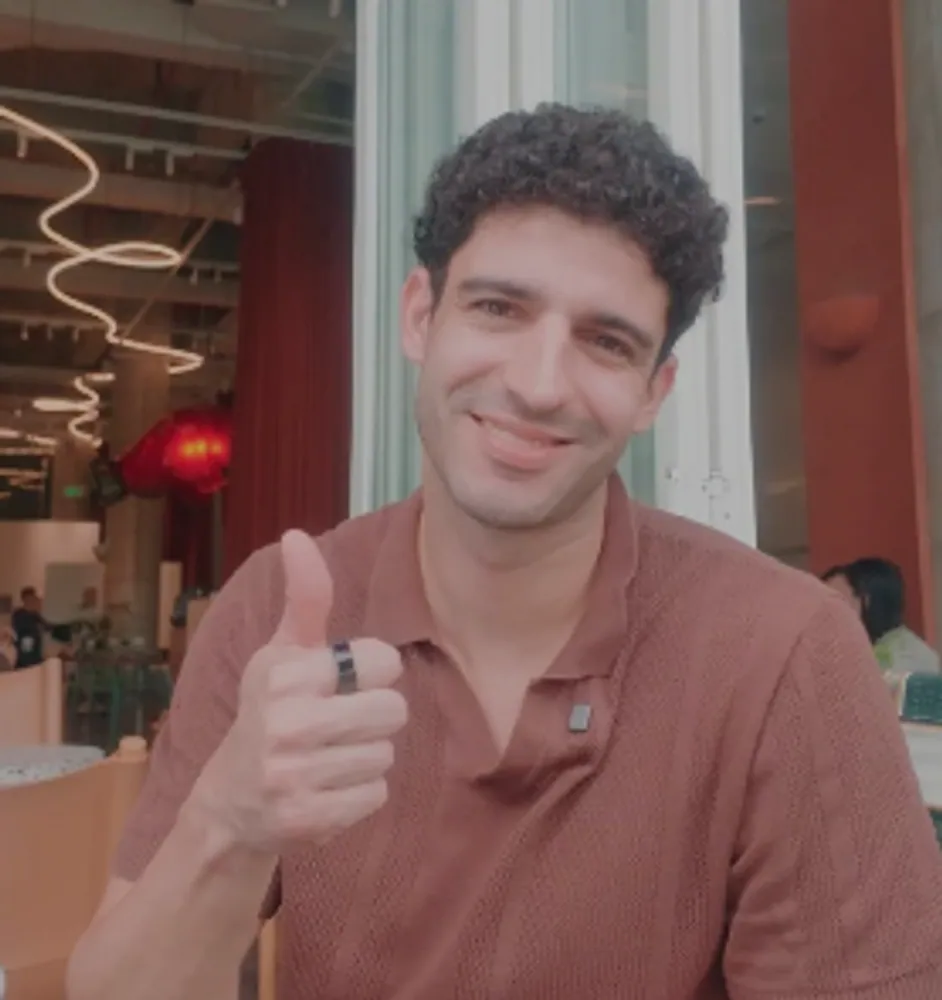 A client giving a thumbs-up in a terracotta polo