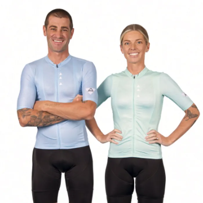 Cyclists in light blue and mint jerseys