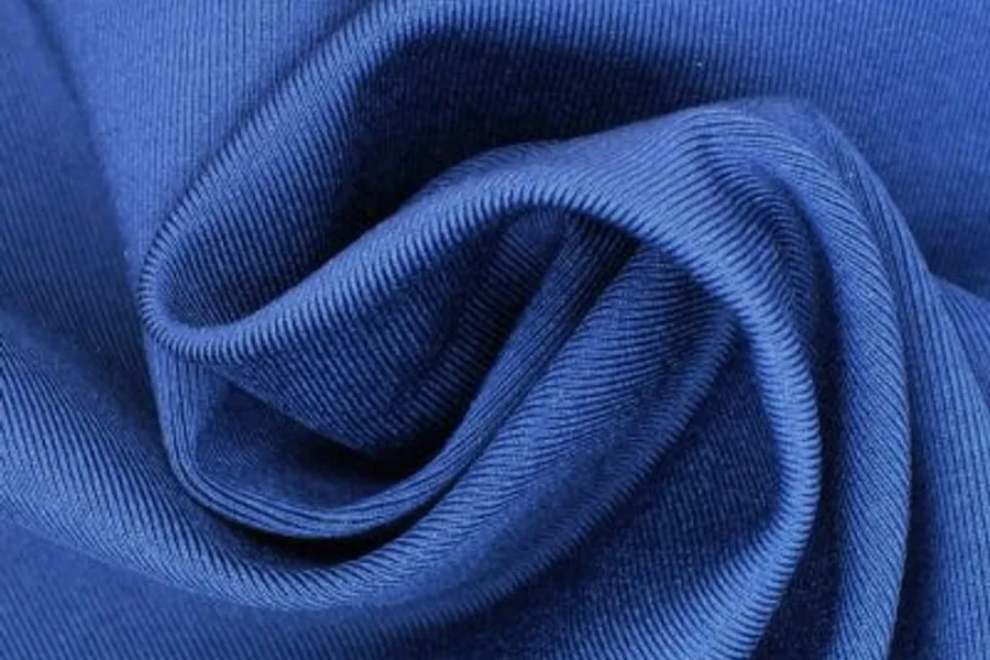 Ribbed blue knit swirled into a fold at the centre of the frame