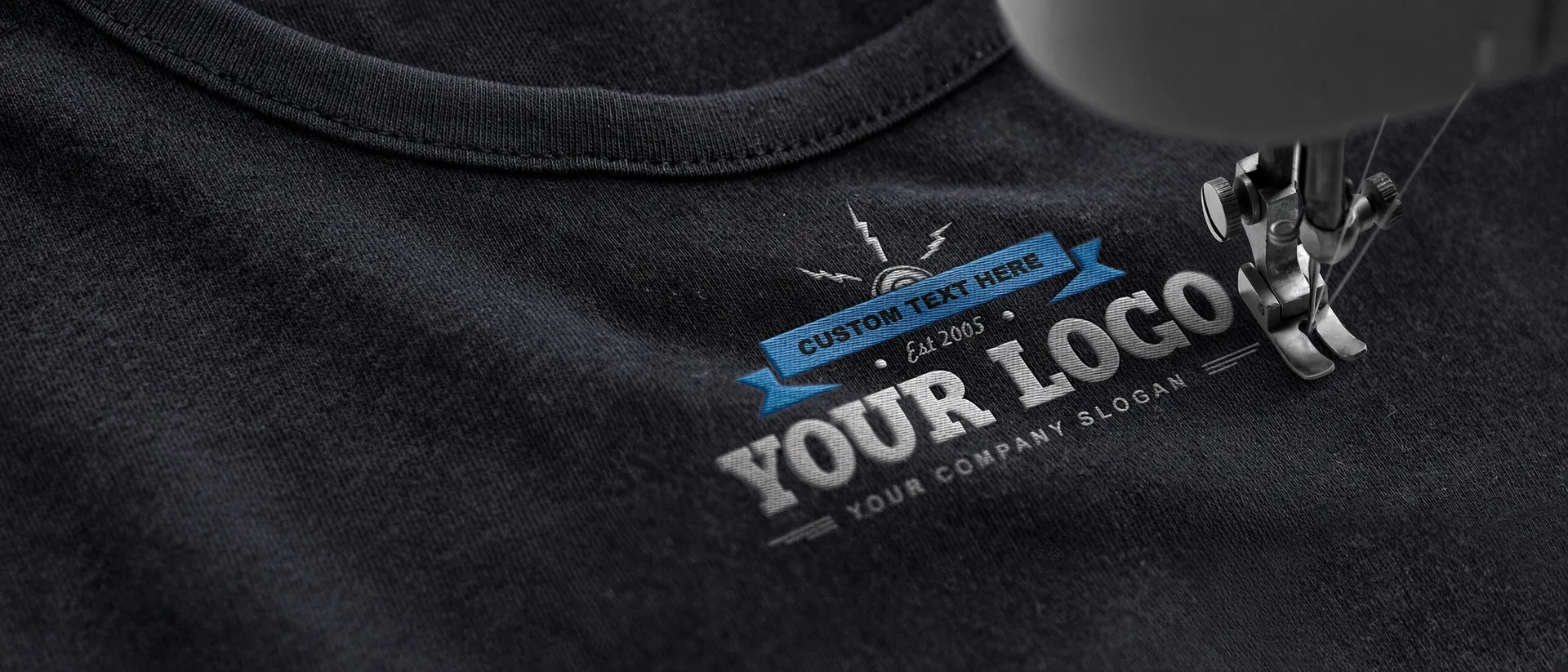 Close-up of an embroidery machine stitching a raised logo into a black tee