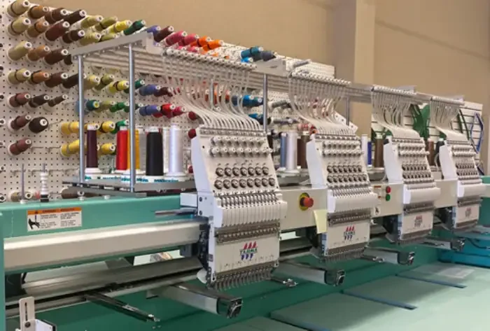 Multi-head embroidery machines in a row along the production floor