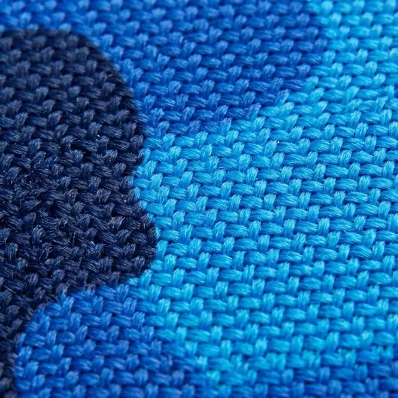 Azure basket-weave cloth with a deep navy shape across it, the two faces side by side