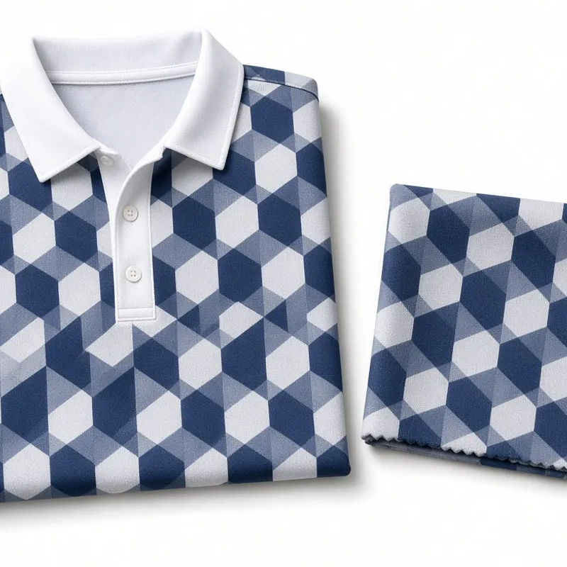 Navy and white geometric print covering a folded polo beside a folded length of the same printed cloth