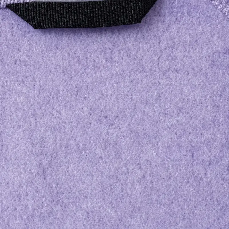 Brushed fleece macro in lavender filling the frame, its napped face catching light below a black hanger loop