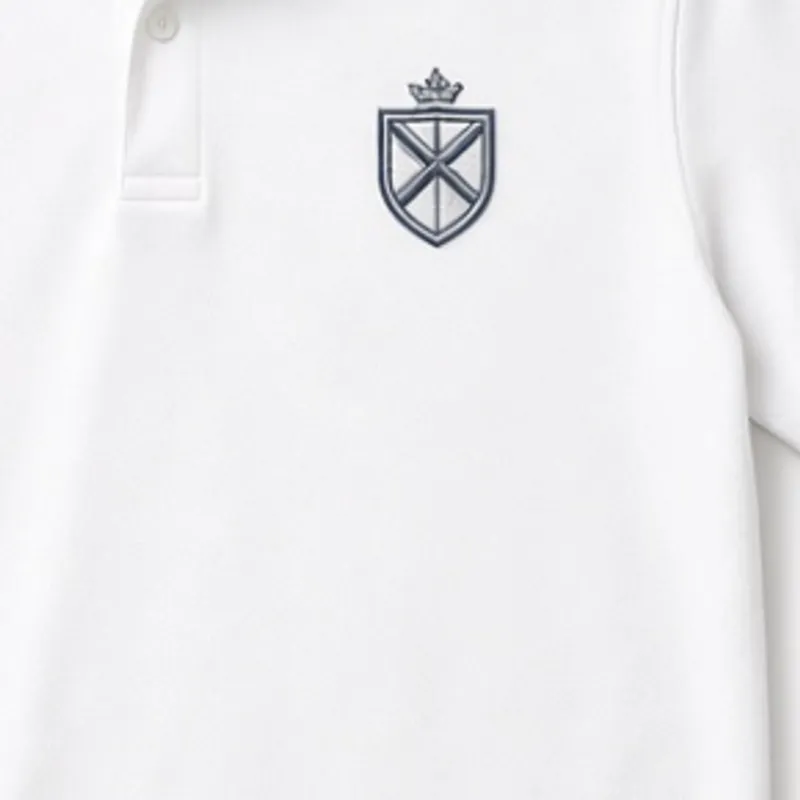 Shield crest in navy with a crown above it, embroidered on the chest of a white polo