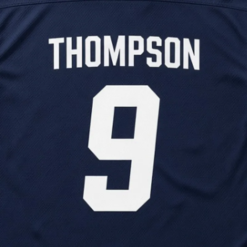Printed on the back of a navy shirt, the name Thompson above a large white 9
