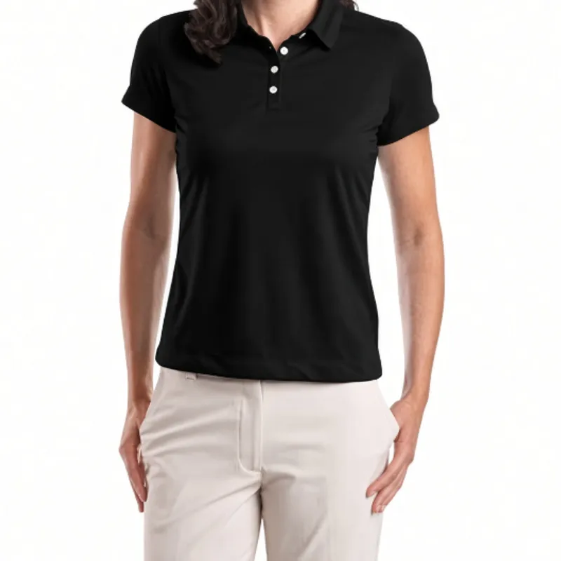 Tailored through the waist, a black ladies’ polo worn over cream trousers