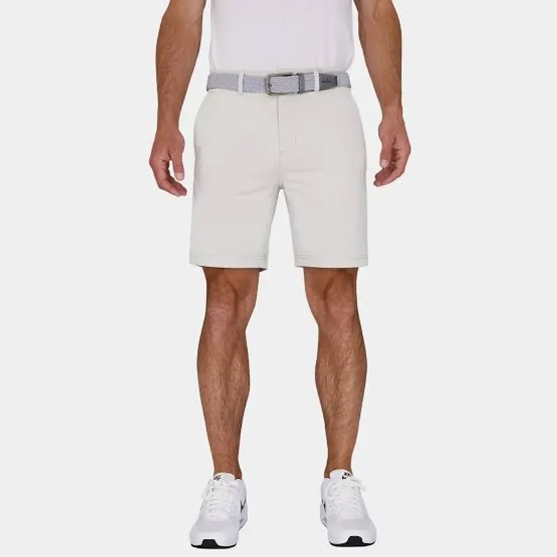 Golf shorts in off-white worn with a pale woven belt under a white tee, shot from the chest down