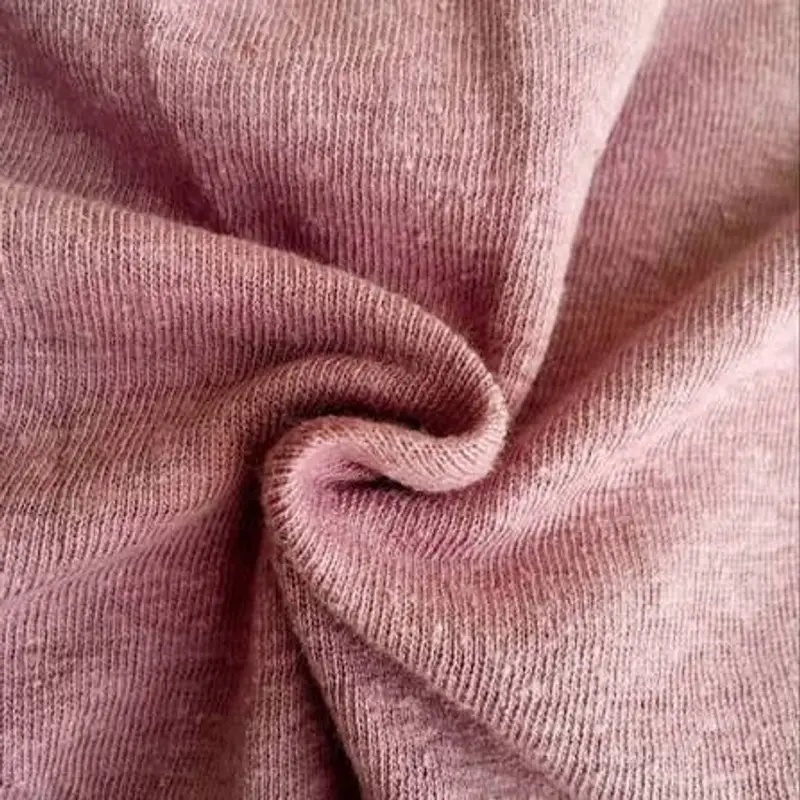 Spiralled in dusty rose, an organic cotton blend knit with a fine rib running across the frame