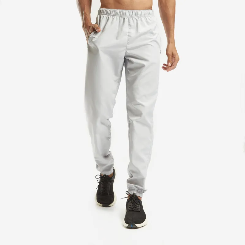 Walking in light grey tapered joggers with an elasticated waist and cuffed ankles