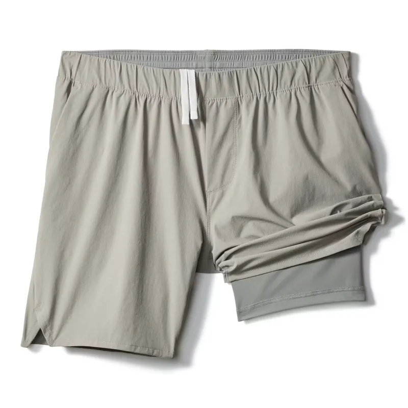 Laid flat, grey lined shorts with the inner liner visible inside the right leg opening