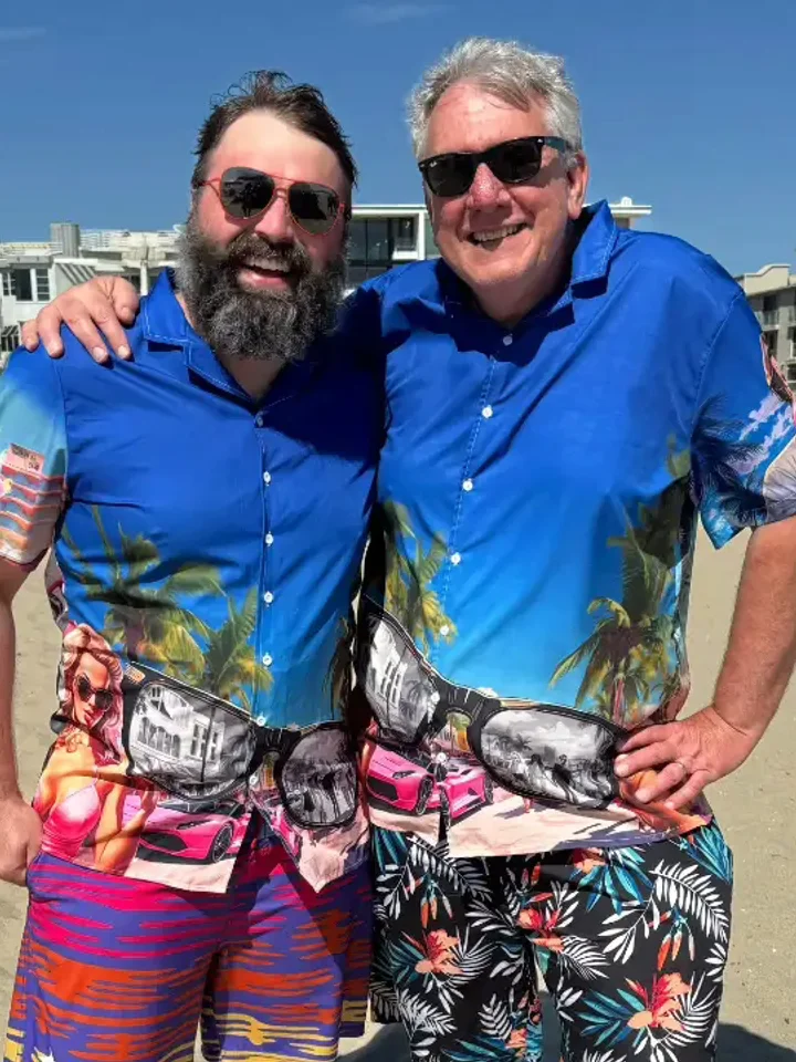Two customers in matching blue ocean-print Hawaiian shirts