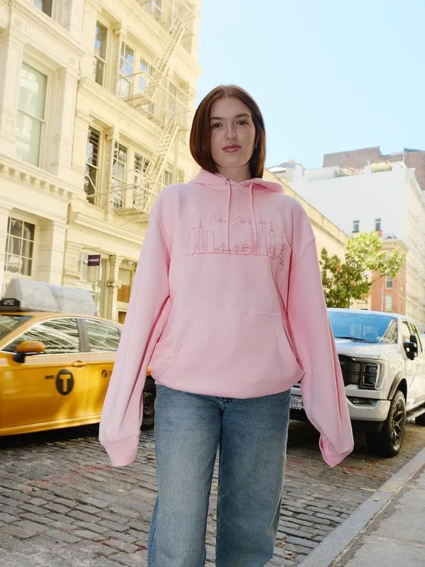 A customer wearing a custom hoodie, portrait