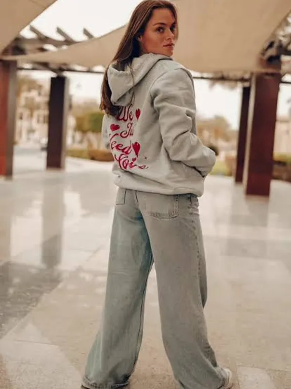 A customer wearing a custom hoodie, studio