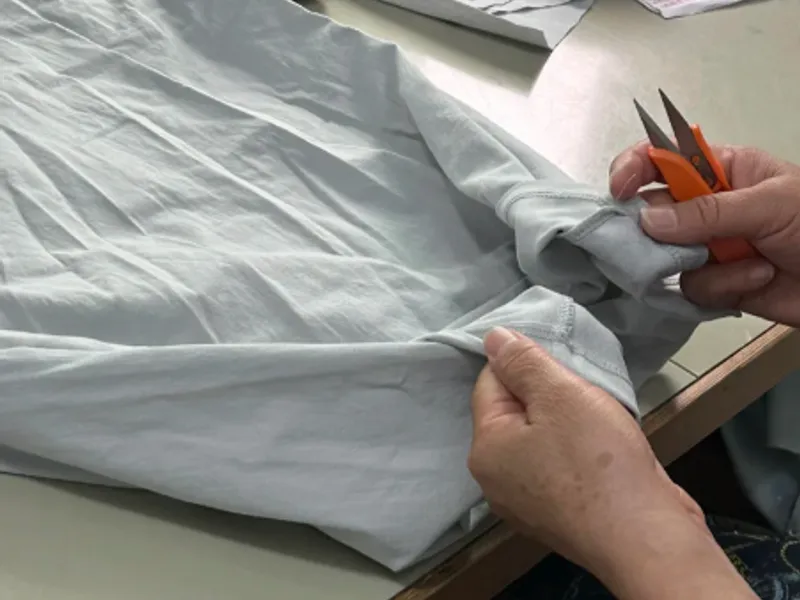 Inspector checking stitching and fit