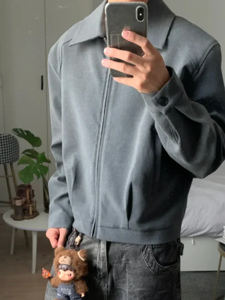 Grey wool-blend zip jacket on a customer, photographed in a mirror indoors