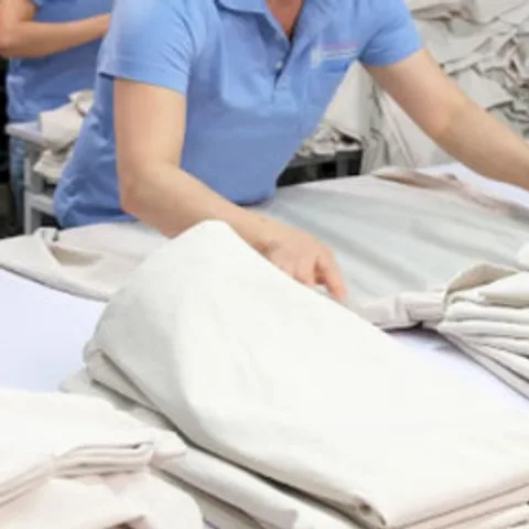 Folded knit garments stacked on a table on the production floor