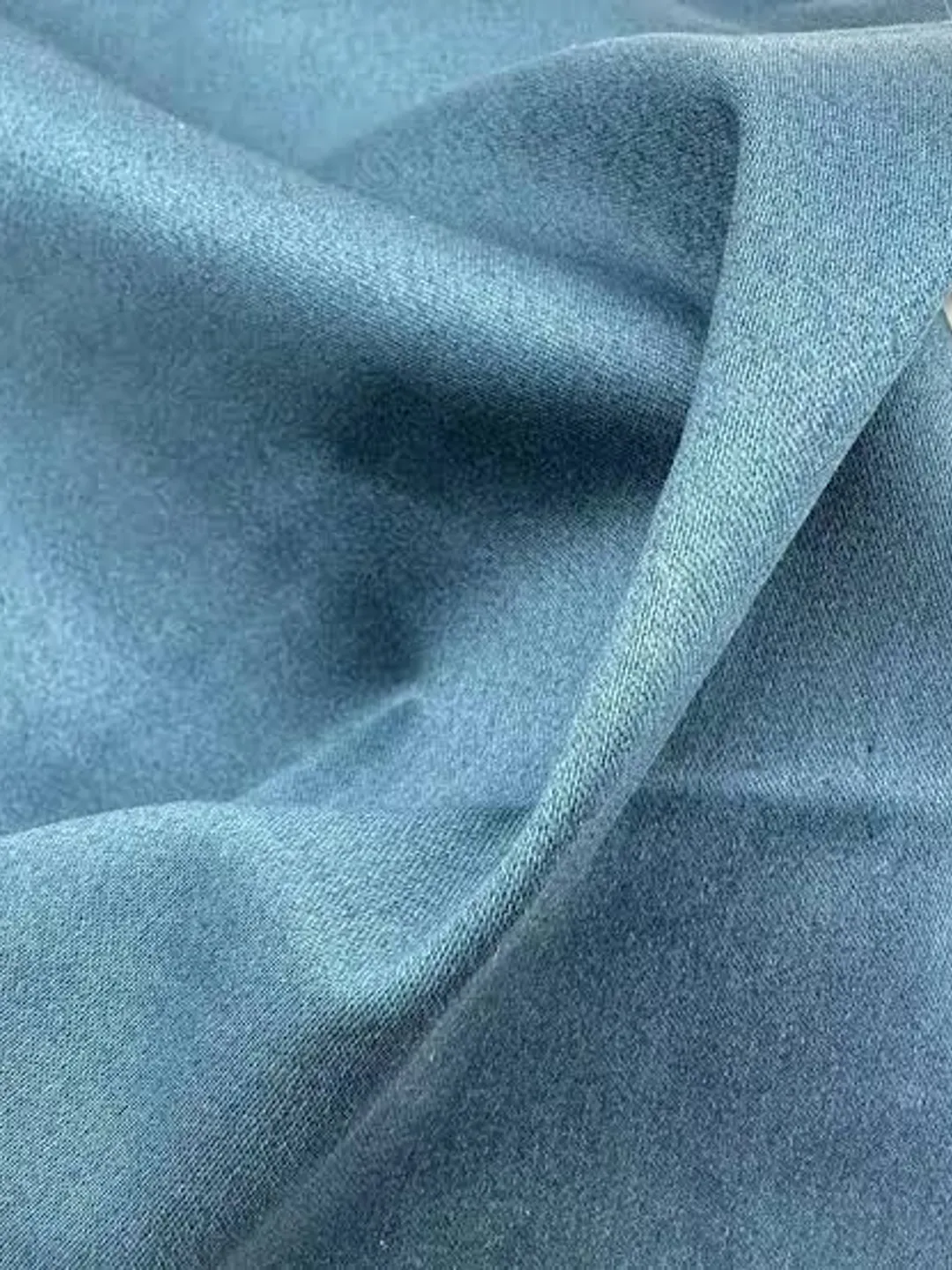 Soft light-blue stretch denim fabric showing its give