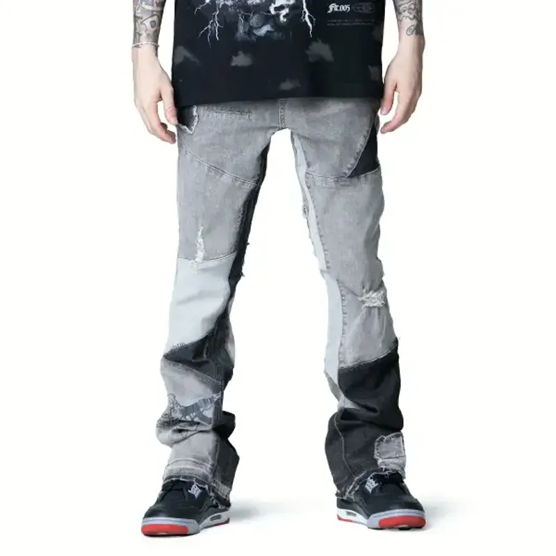 Grey and black paneled stacked jeans with patches