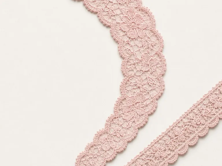 Scalloped floral lace galloon laid out in two lengths