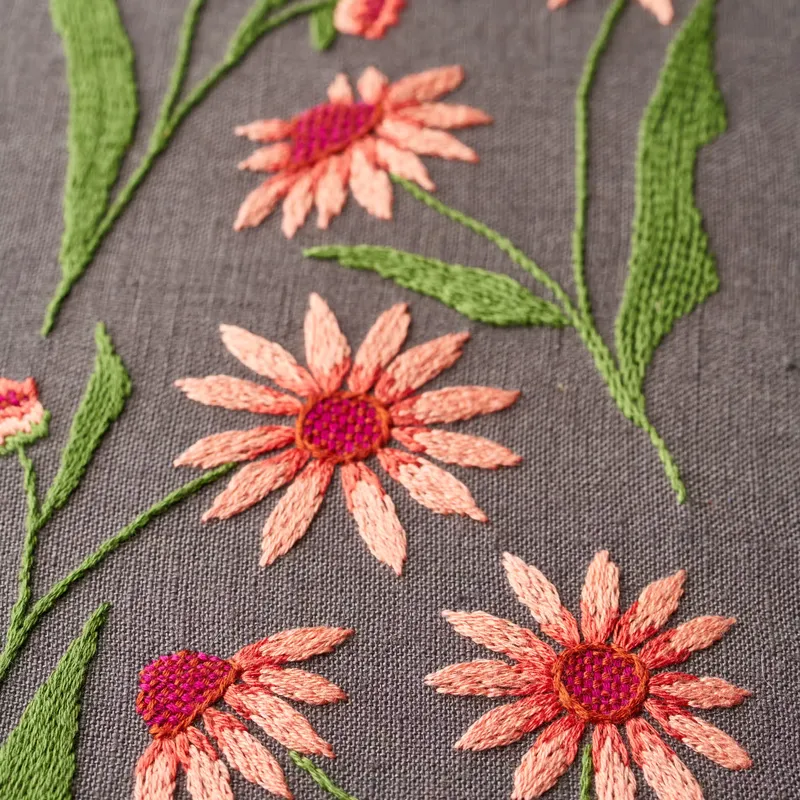 Embroidered logo stitched on the chest of a Hawaiian shirt