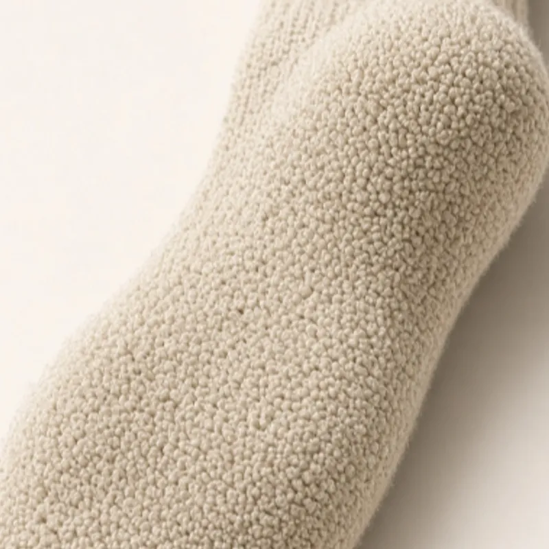 Cream terry loops photographed close across the foot of a sock
