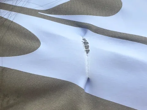 Close-up of a printed panel puckering along a seam on stretch fabric