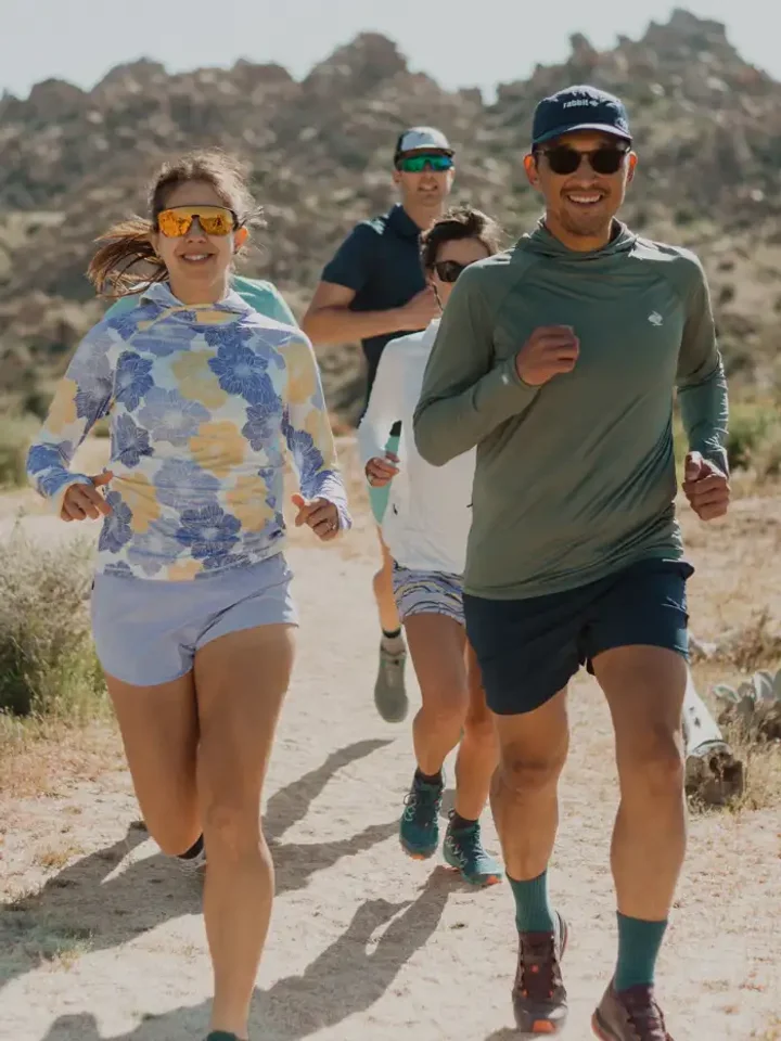 Two runners in shorts and training tops on a desert trail