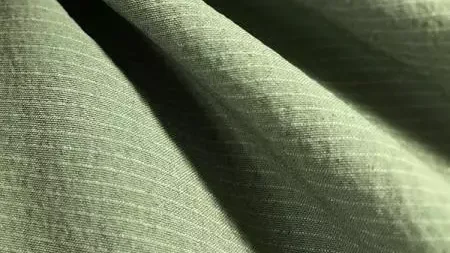 Close-up of a green anti-odour-treated knit fabric falling in soft folds
