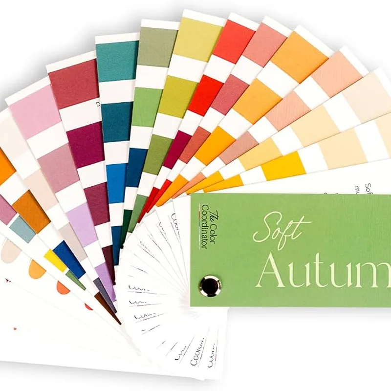Swatch cards fanned open, the green Soft Autumn card lying across the others