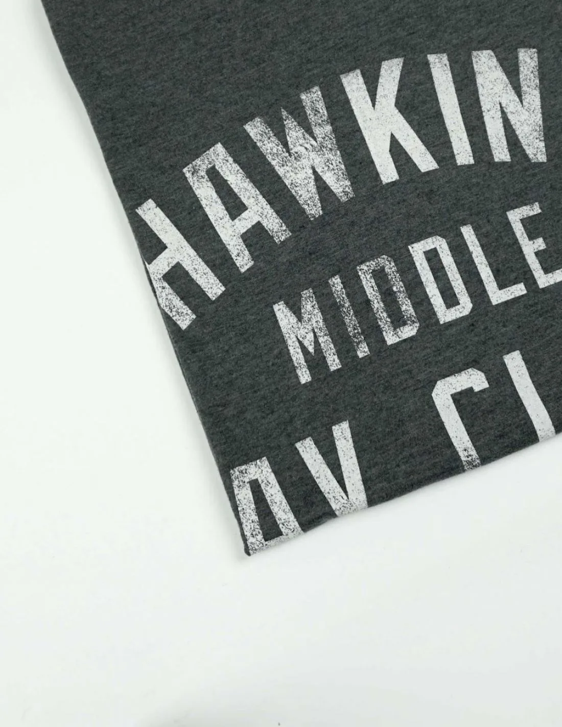 A white distressed print on dark charcoal jersey against a white background