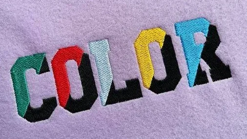 Multicoloured satin-stitch embroidery on lilac fabric