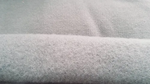 Close-up of pale grey brushed fleece, showing the fuzzy nap of the inner face