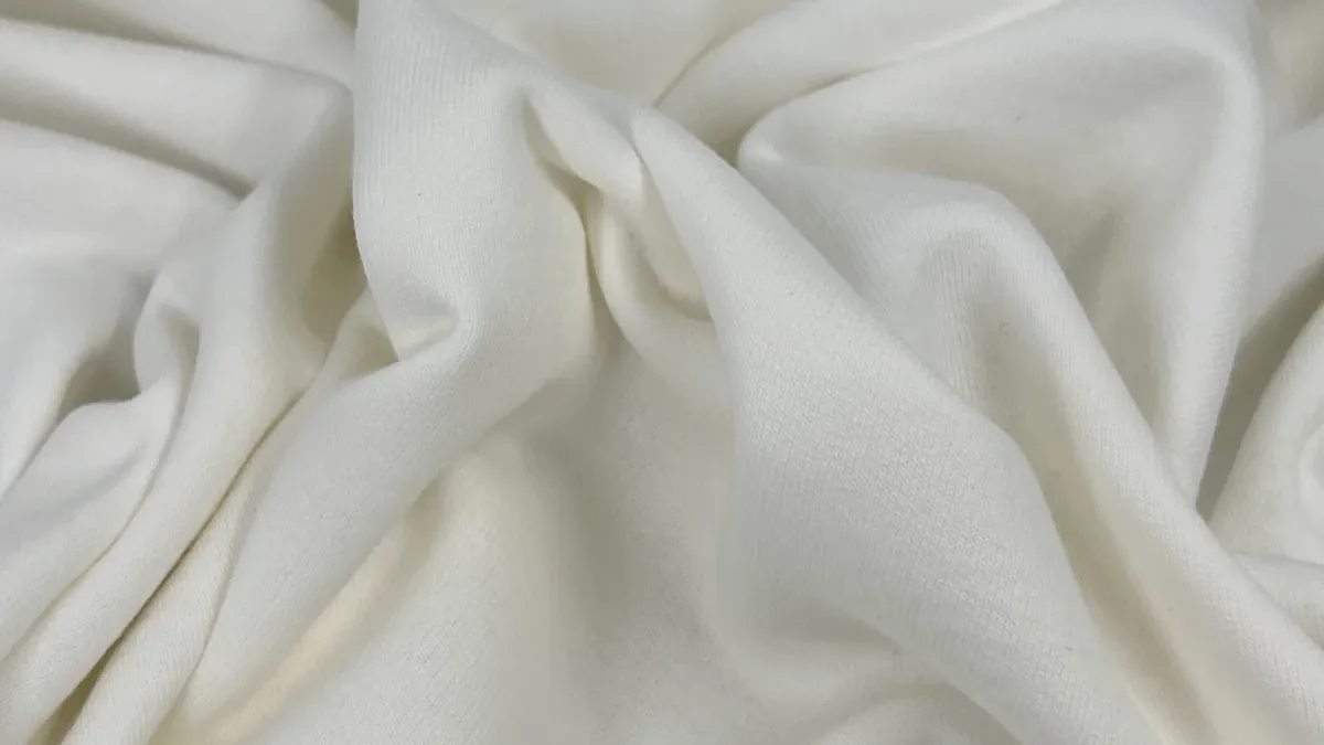 Close-up of soft white ring-spun cotton fleece with a clean, smooth surface