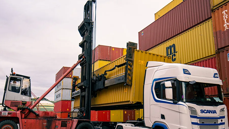 Containers being loaded onto a truck at a freight terminal