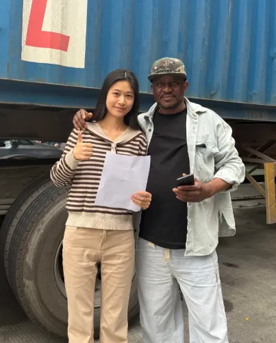 Tunde Adeleke with a JaceApparel producer at the shipping container