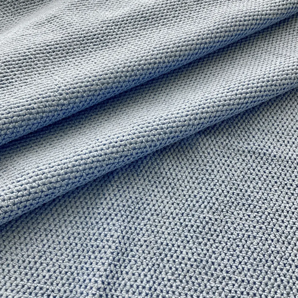 Pale blue pebbled microfibre, folded along two horizontal creases