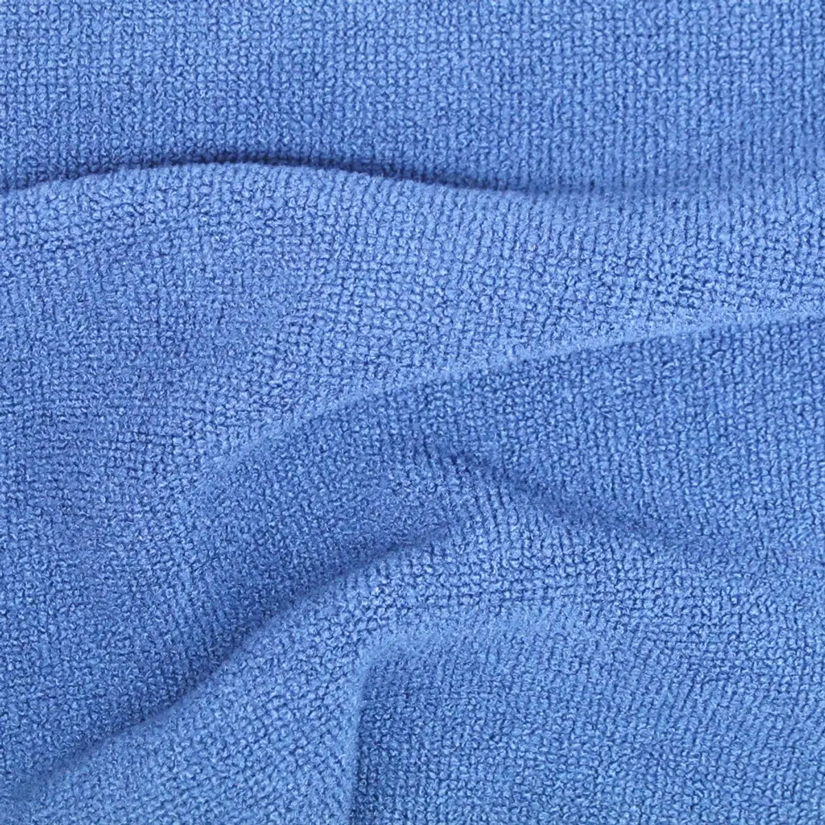 Terry loops in blue filling the frame, a soft fold crossing the middle
