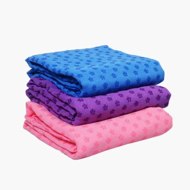 Yoga towels in blue, purple and pink, stacked one on another