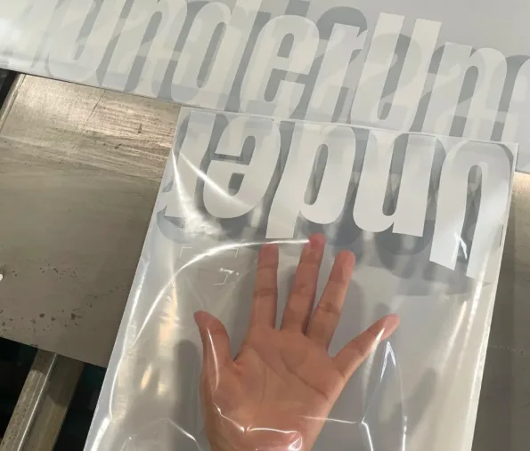 A hand pressing a compostable mailer bag